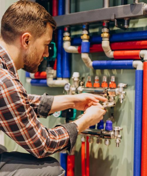 young-engineer-adjusting-autonomous-heating-Custom.jpg