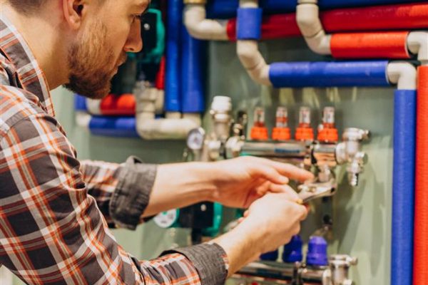 young-engineer-adjusting-autonomous-heating-Custom.jpg